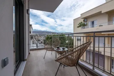 a balcony with two chairs and a table at MAGNOLIA Luxury Chania Central Apartments in Chania Town