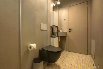 a bathroom with a toilet and a glass door at MAGNOLIA Luxury Chania Central Apartments in Chania Town