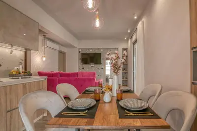 a dining room with a wooden table and chairs at MAGNOLIA Luxury Chania Central Apartments in Chania Town