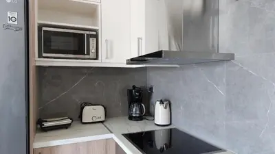 a kitchen with a sink and a microwave at Ioanna Apartment 1 in Chania Town
