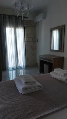a bedroom with two beds with towels on them at Ioanna Apartment 1 in Chania Town