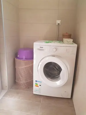 a washing machine in a corner of a room at happy travelers studio free parking in Chania Town