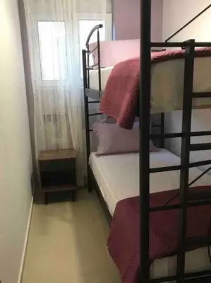 a bedroom with two bunk beds and a window at Anastasia’s Home in Chania Town