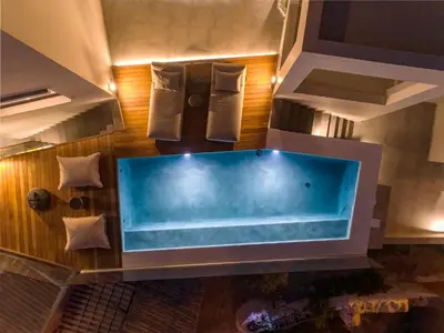 a large blue tub in a room with at Alectrona Living Crete, Apartment Olīvea in Plataniás
