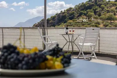 a plate of fruit on a table on a balcony at Karel house in Karés