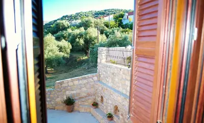 a view from a window of a stone wall at Mouri Villa in Mouríon
