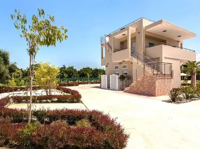 a house with a staircase in front of it at Green Orange Villa near Platanias in Chania Town