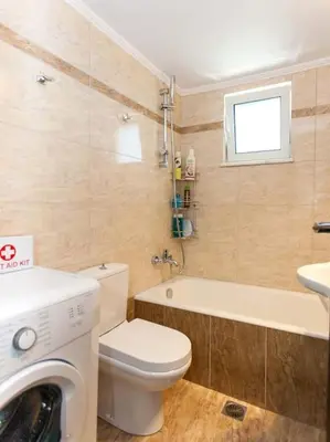 a bathroom with a toilet and a sink and a washing machine at Green Orange Villa near Platanias in Chania Town