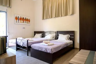 a room with two beds in a room at Green Orange Villa near Platanias in Chania Town
