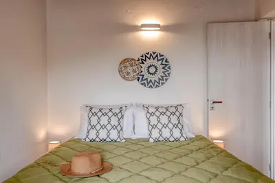 a bedroom with a bed with a hat on it at Elma's Villa in Kissamos