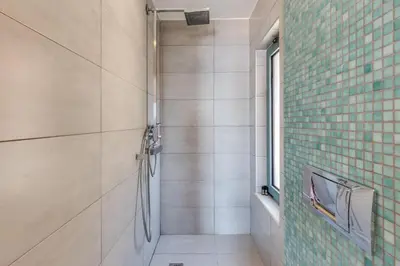 a bathroom with a shower and a window at Unlimited Blue in Chania Town