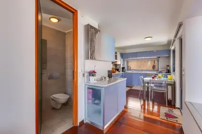a kitchen with blue cabinets and a sink and a toilet at Unlimited Blue in Chania Town