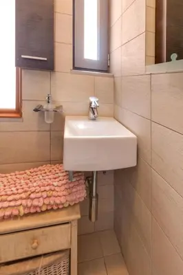a bathroom with a white sink and a counter at Unlimited Blue in Chania Town