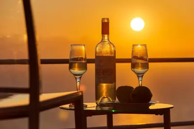 a bottle of wine and two glasses on a table at Unlimited Blue in Chania Town