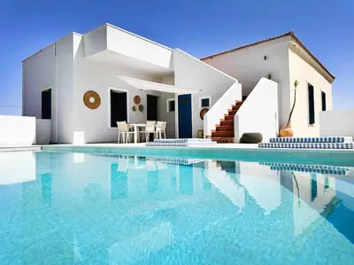 a villa with a swimming pool in front of a house at Villa Xanthippe in Vamos