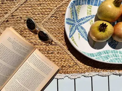 a book and a plate of fruit and a plate of glasses at Villa Xanthippe in Vamos