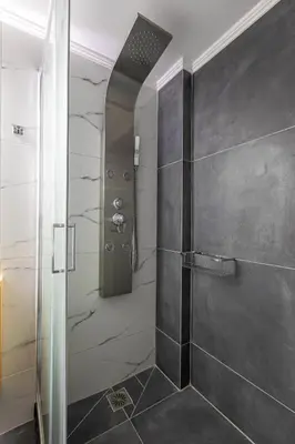 a shower with a glass door in a bathroom at Neaira City Apartment Near The Beach in Chania Town