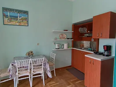 a kitchen with a table and chairs in a kitchen at The blackbird's nest in Chania Town