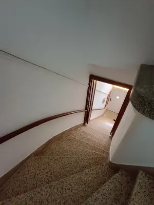 an empty room with a door and a stair case at The blackbird's nest in Chania Town