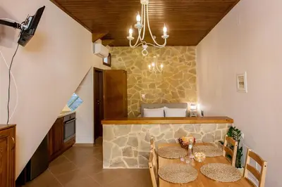a kitchen and dining room with a table and chairs at Pleiades Apartments in Chania Town