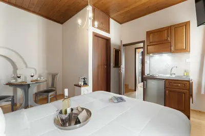 a kitchen with a table with a bottle of wine on it at Pleiades Apartments in Chania Town