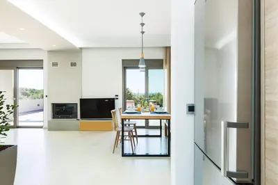 a kitchen and dining room with a table and chairs at Estel Residences in Chania Town
