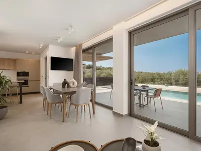 a kitchen and dining room with a view of a pool at Estel Residences in Chania Town