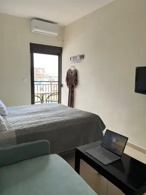 a bedroom with a bed and a laptop on a table at Candia Hotel in Chania Town
