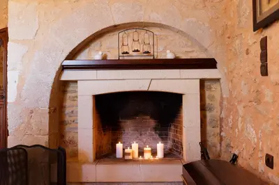 a stone fireplace with candles in it at Patriko Villa in Kissamos