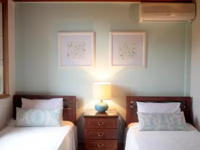 a bedroom with two beds and a lamp on a night stand at Patriko Villa in Kissamos