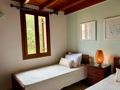 a bedroom with two beds and a window at Patriko Villa in Kissamos
