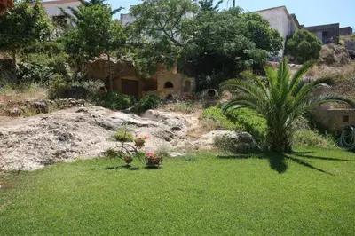 a garden with some plants in the grass at Patriko Villa in Kissamos