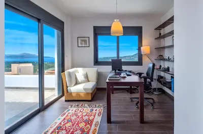 an office with a desk and a chair and window at Villa Lefki in Vamos