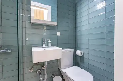 a bathroom with a toilet and a sink at Little gem by the sea in Chania Town
