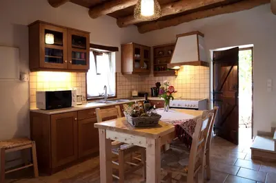 a kitchen with a table and a kitchen with wooden cabinets at Citrea Villa in Fournés