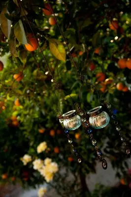a pair of glass bells hanging from a tree at Citrea Villa in Fournés