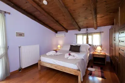 a bedroom with a bed with two towels on it at Citrea Villa in Fournés