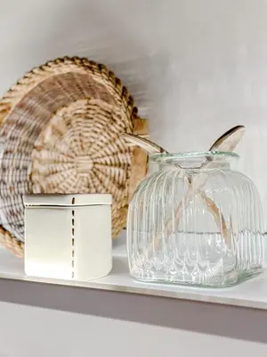 a glass vase and a basket on a shelf at Mountain Bliss Guesthouse 1 next to Sougia in Agrilés