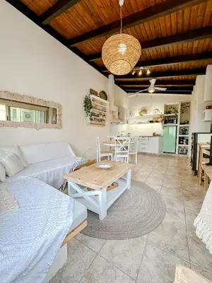 a living room with a couch and a table at Mountain Bliss Guesthouse 1 next to Sougia in Agrilés