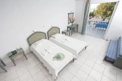 a hospital room with two beds and a balcony at Papidakis Studios in Agia Marina Nea Kydonias