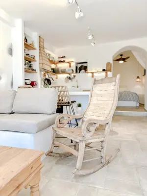 a living room with a chair and a couch at Mountain Bliss Guesthouse 2 next to Sougia in Agrilés
