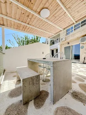 an outdoor patio with a table and chairs at Mountain Bliss Guesthouse 2 next to Sougia in Agrilés