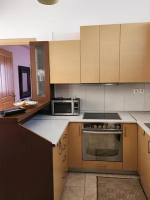 a kitchen with a stove and a microwave at Nora Apartment in Almyrida in Chania Town