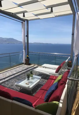 a balcony with a view of the ocean on a ship at Seafront Ravdoucha Epavlis Athina Villa - Pool, Gym, Sauna, Private Parking, WiFi in Ravdhoúkha
