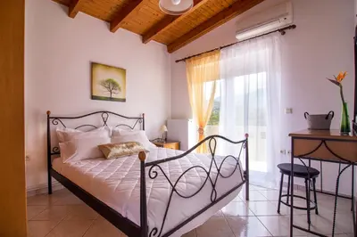 a bedroom with a bed and a window at Villa Marianna in Vryses