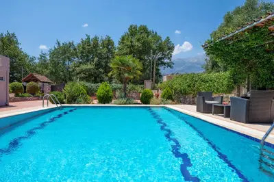 a swimming pool with blue water in a yard at Villa Marianna in Vryses