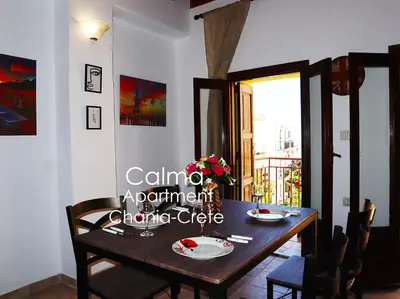 a dining room with a wooden table and chairs at Calma Apartment Chania in Chania Town