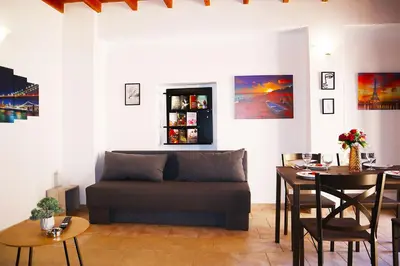 a living room with a couch and a table at Calma Apartment Chania in Chania Town