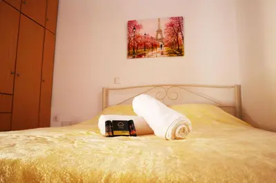 a bed with a phone and a towel on it at Calma Apartment Chania in Chania Town