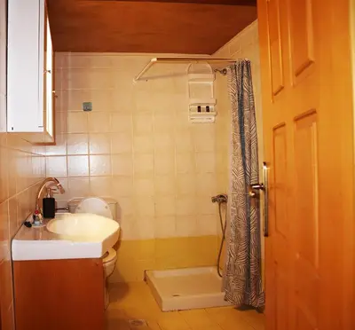 a bathroom with a sink and a toilet and a shower at Calma Apartment Chania in Chania Town